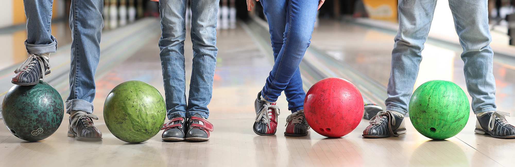 Kids with bowling balls and bowling shoes